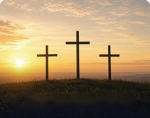 Three crosses on a hill at sunrise